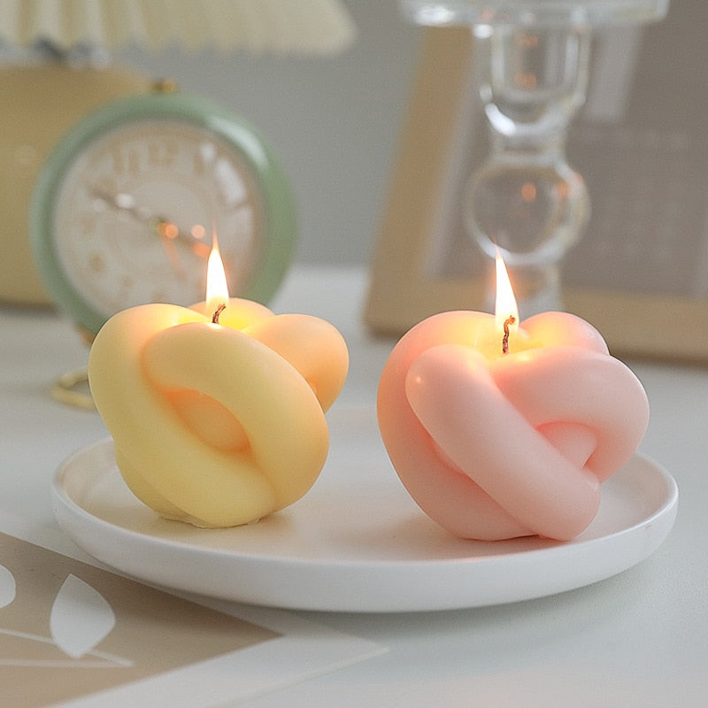 Decorative candles in the shape of an apple with rope details