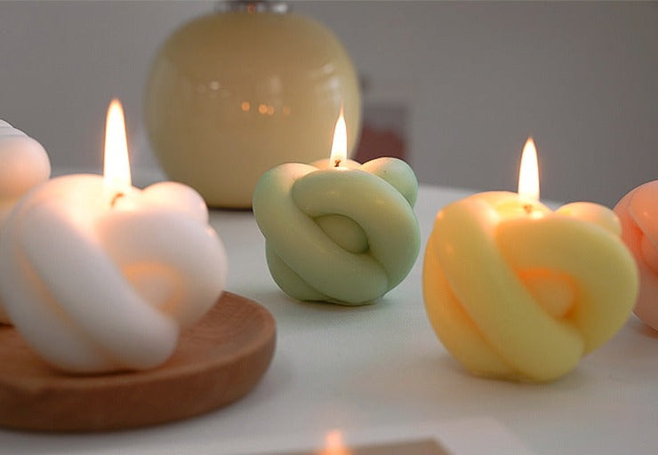 Decorative candles in the shape of an apple with rope details