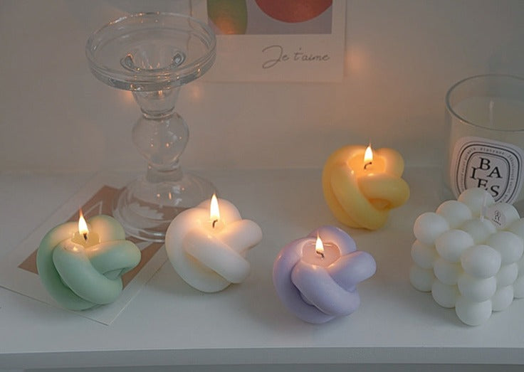 Decorative candles in the shape of an apple with rope details