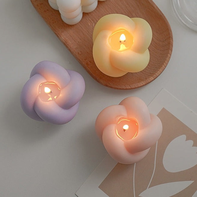 Decorative candles in the shape of an apple with rope details