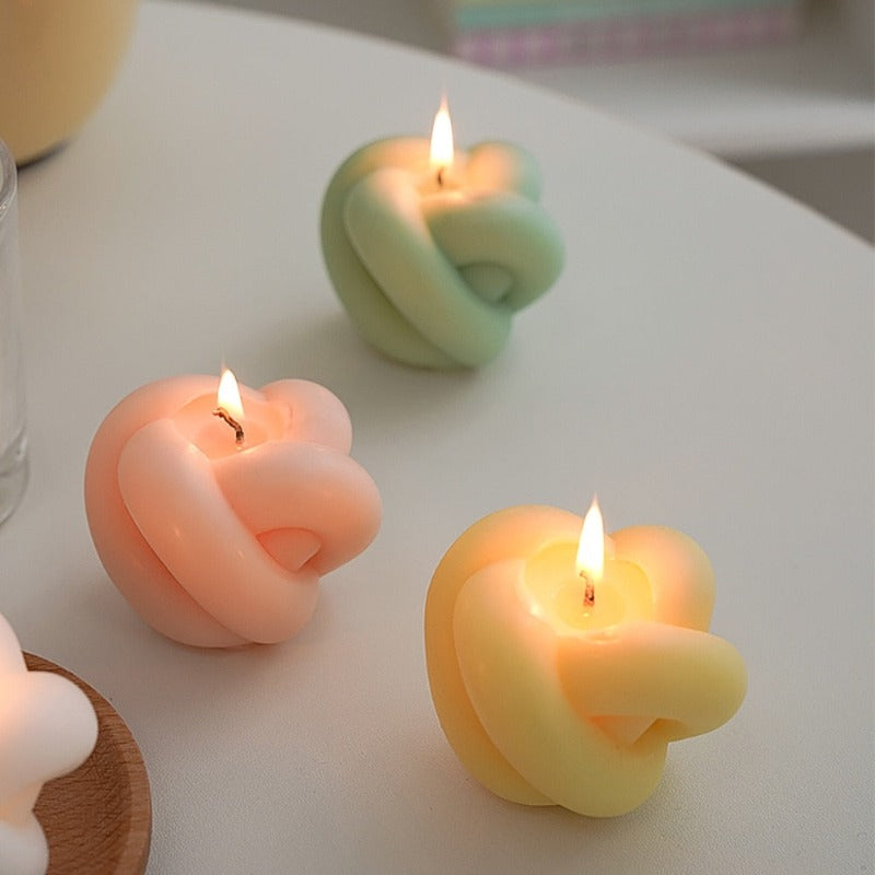 Decorative candles in the shape of an apple with rope details